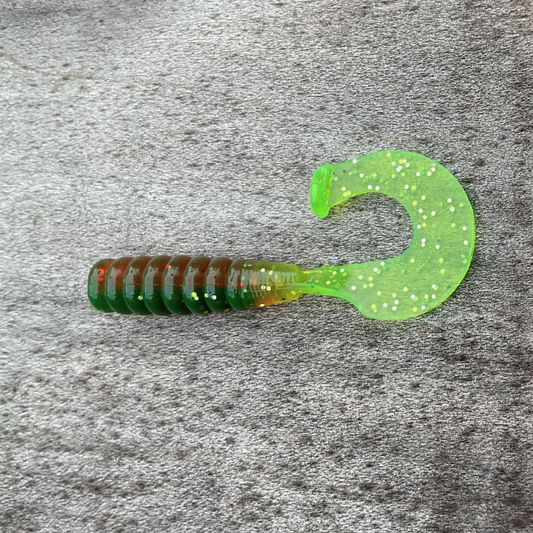 2 inch curly tail kicker in green and brown with glitter, perfect for crappie, bluegill, trout, and bass fishing.